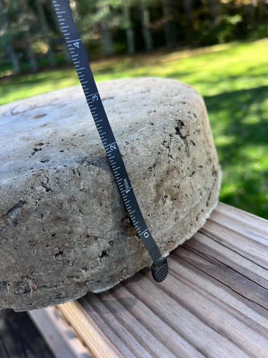 Ruler on a stone surface with a blurred outdoor background